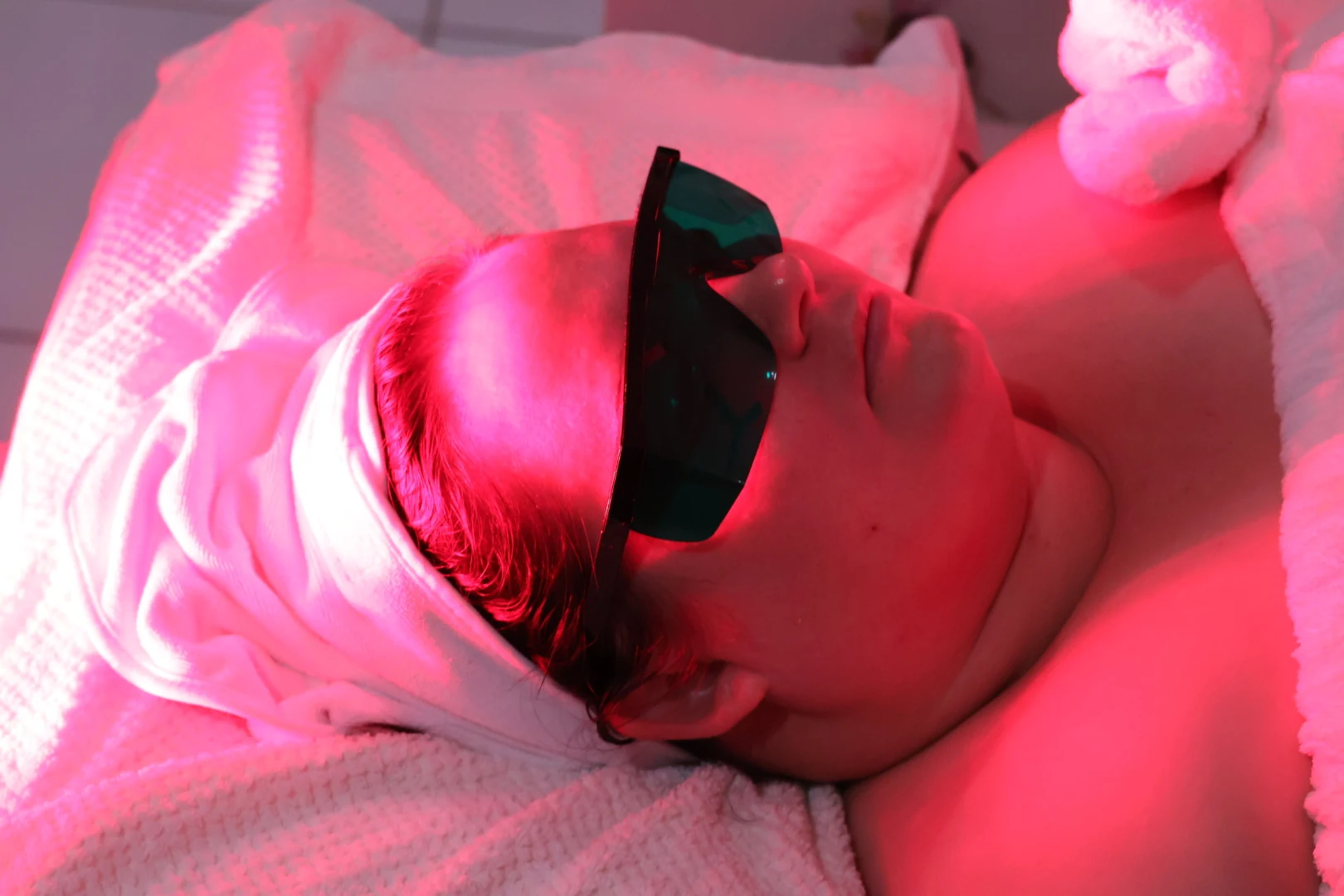 Client receiving an LED facial treatment at Grace Studios CQ